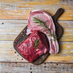 fresh-meat-beef-sliced-and-pork-chops-herb-spices-rosemary-on-wooden-cutting-board-background-raw-beef-steak-free-photo